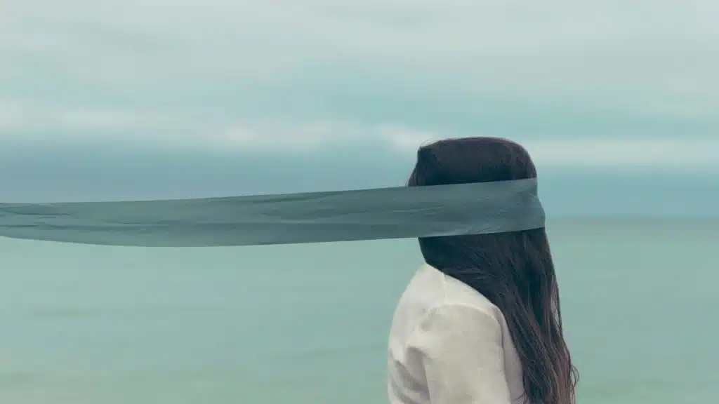 A woman with a blindfold being controlled