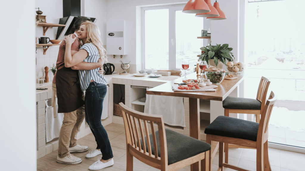 A couple hugging in the kitchen