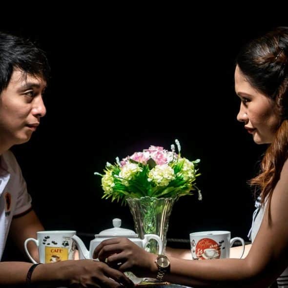 A man and woman facing each other