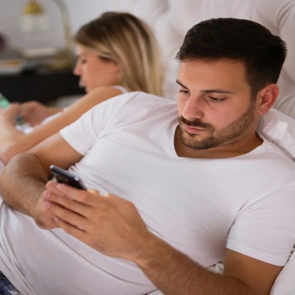 A couple busy with their phones