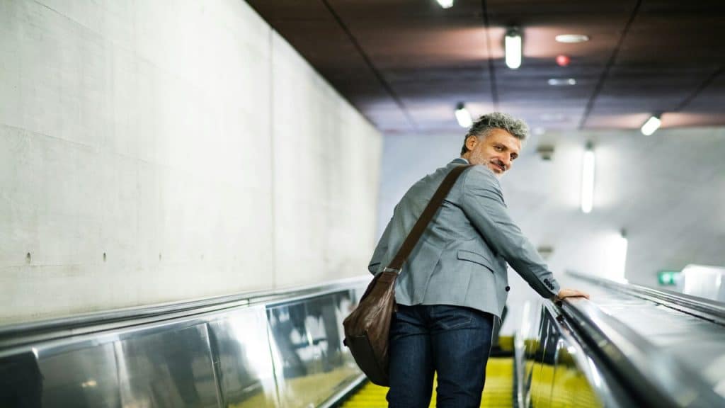 A mature man on an escalator