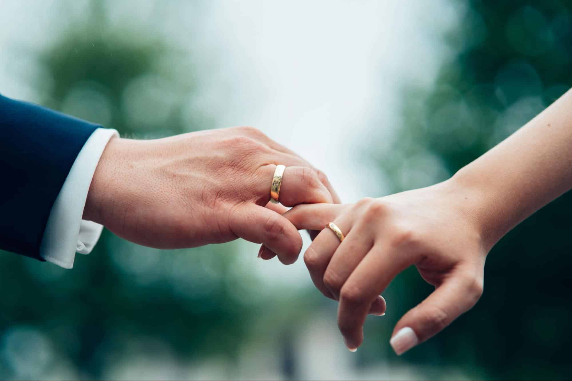 A married couple holding hands.