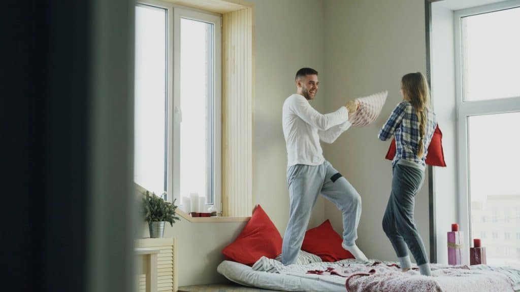 A couple having a pillow fight