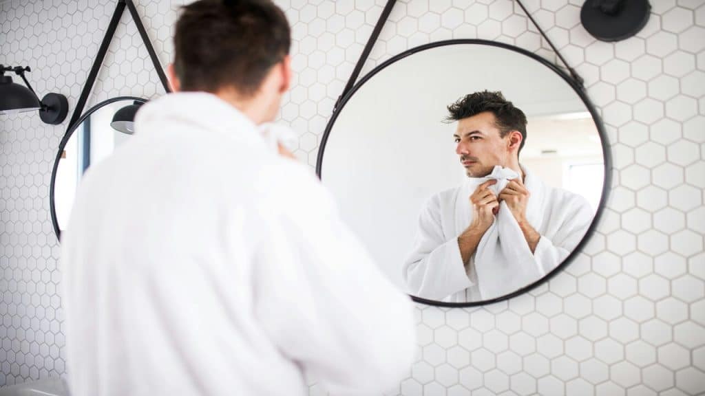 A man looking at himself in the mirror