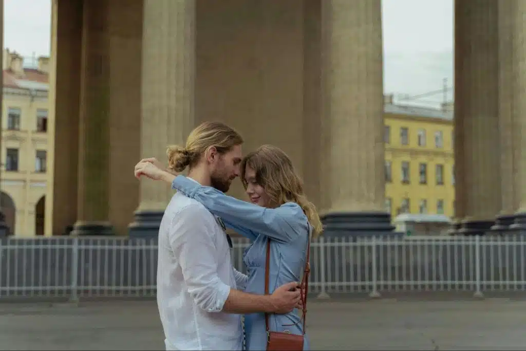 A man and woman hugging a woman at the public