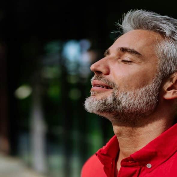 A handsome mature man taking a deep breath