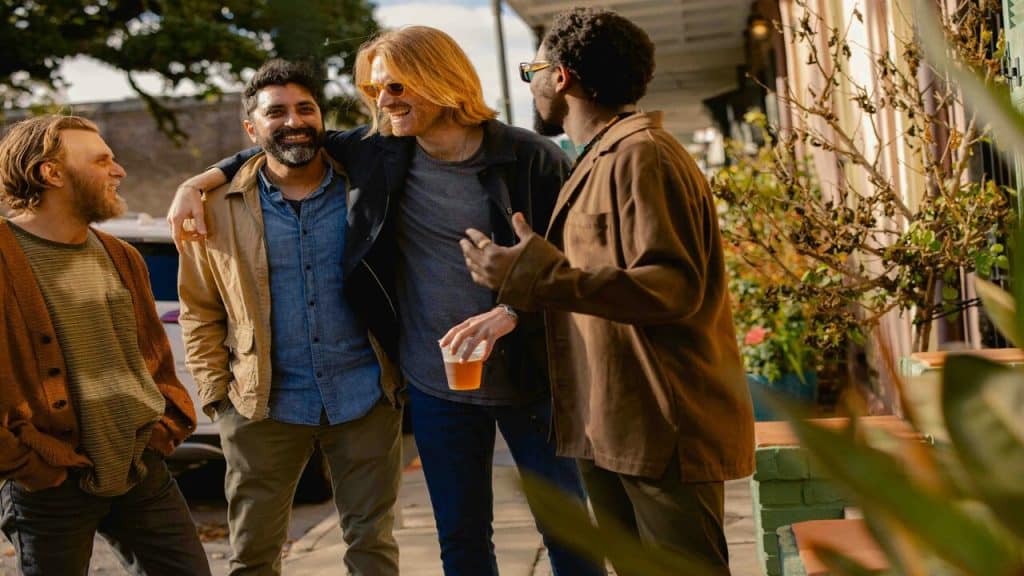 Male friends laughing outdoors