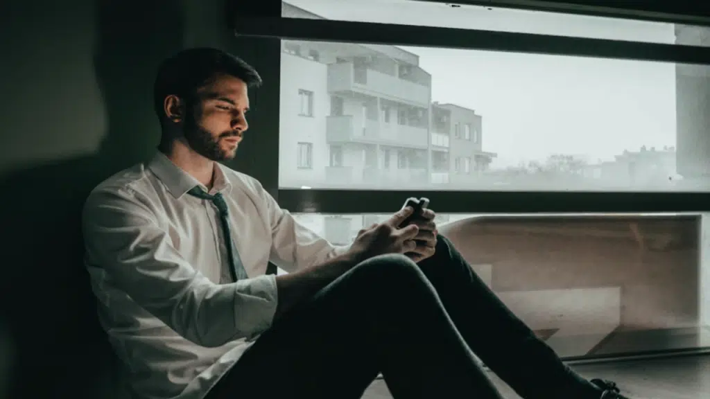 A man looking sad while texting