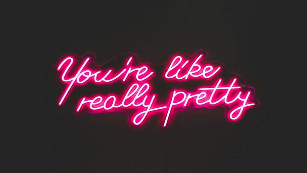 A neon light spelling out “you’re pretty”