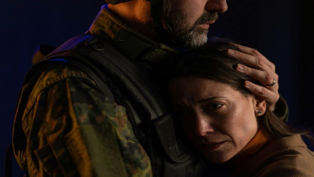 A woman crying while hugging her husband