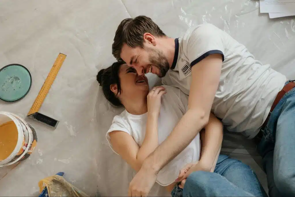 A man and woman laying on ground