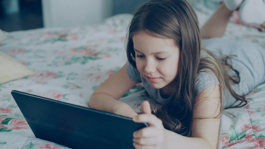 A kid using her iPad