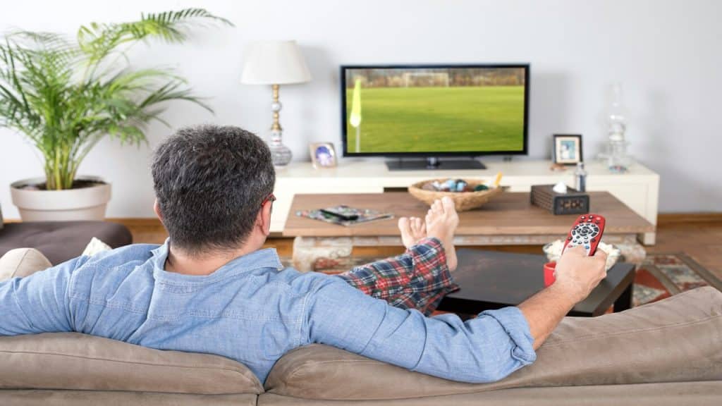 A man watching TV by himself