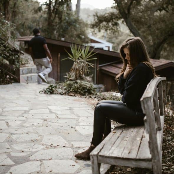 A woman sitting at the bench