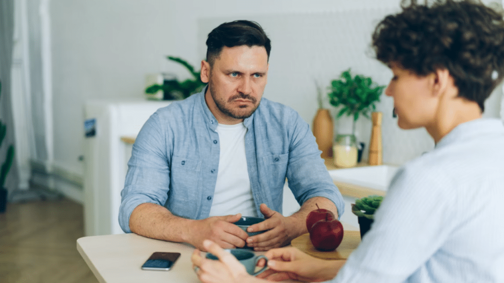 A man looking angrily at his girlfriend
