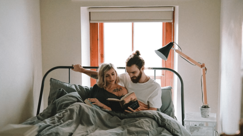 A couple reading in bed together 