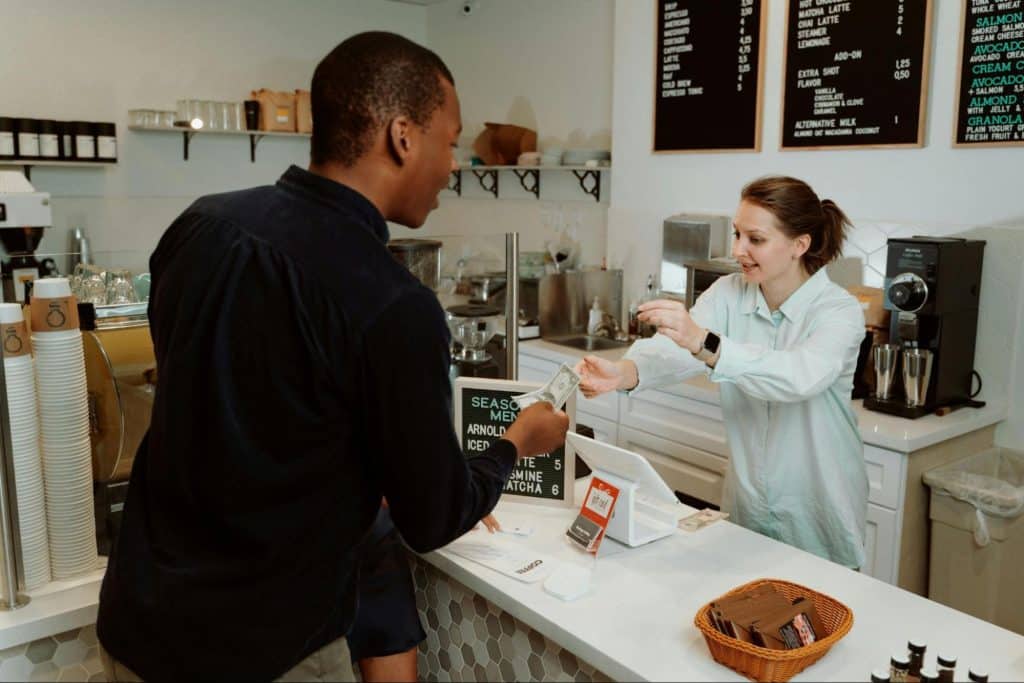 A man being kind to the cashier 