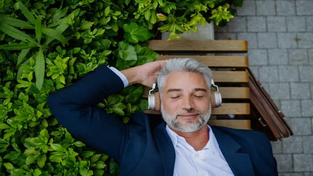 A man enjoying music outdoors
