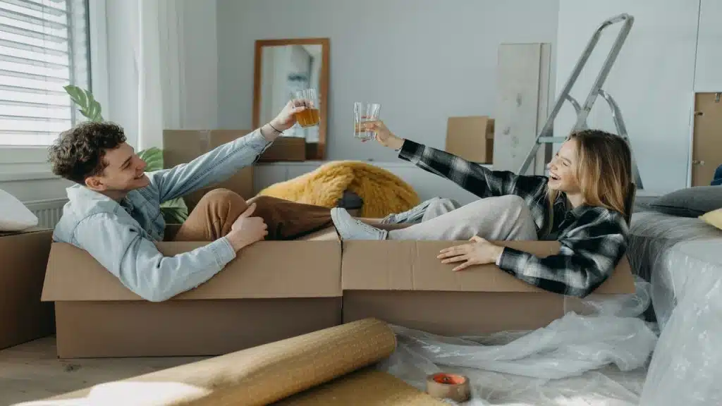 A couple laughing during their move