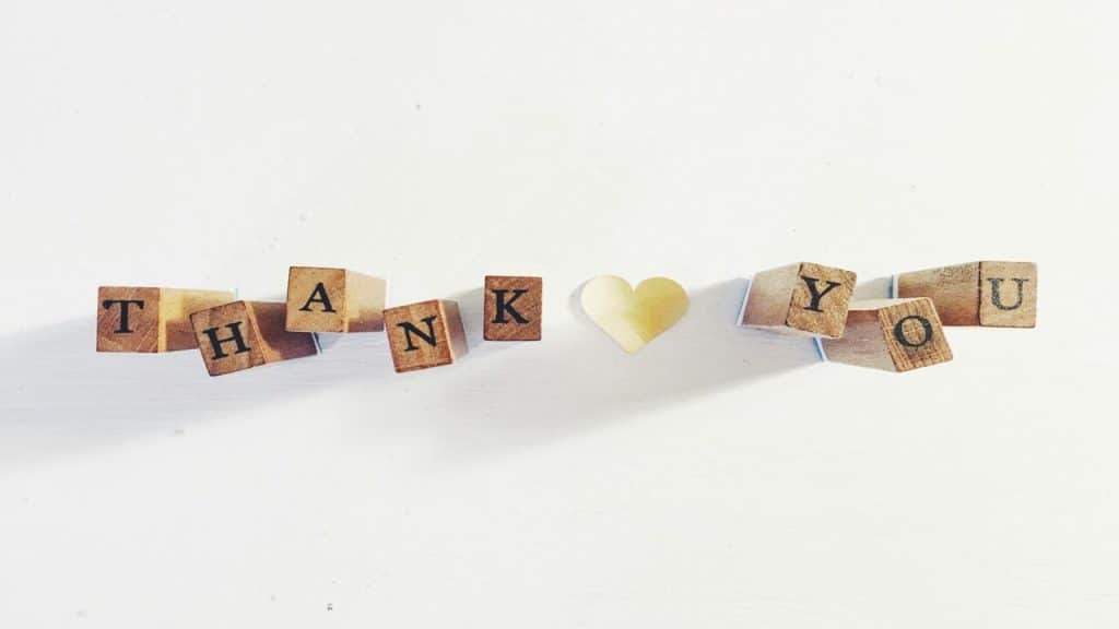 Wooden blocks spelling out “thank you”