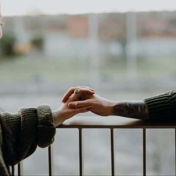 A man and woman holding hands together