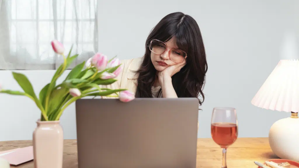 A woman looking sad while working.