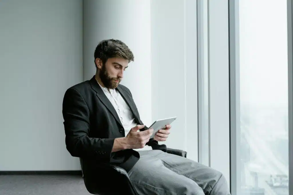 A man sitting on a table with a tablet