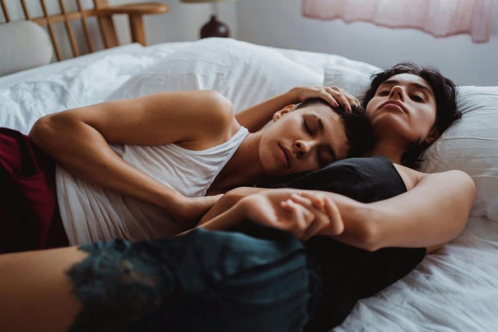A man and woman sleep together