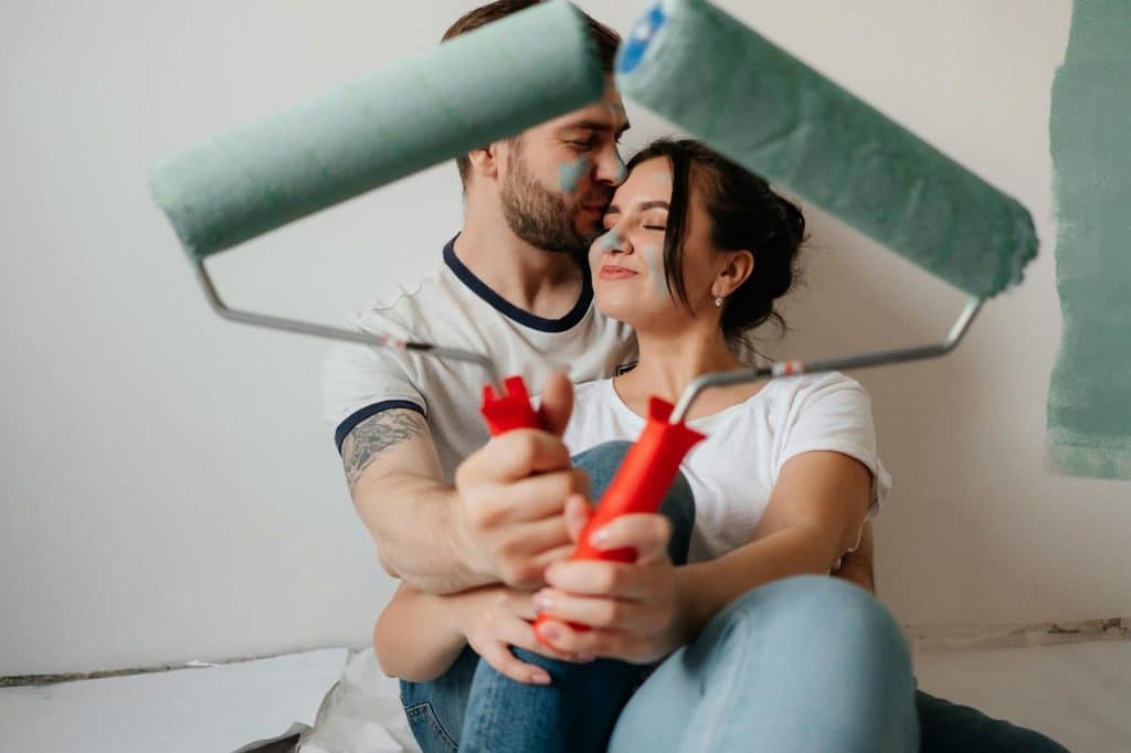 A man kissing a woman’s forehead