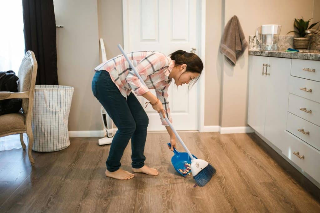 A woman sweeping floor