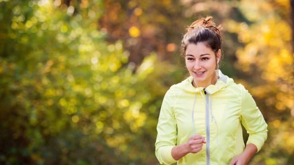 A woman jogging on a nature trail