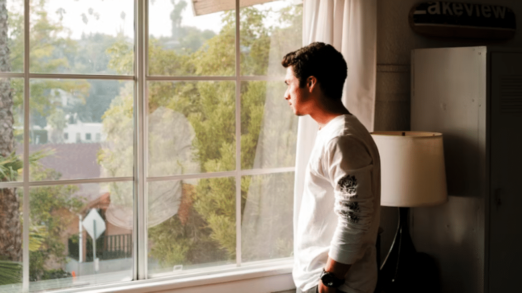 A man looking out the window