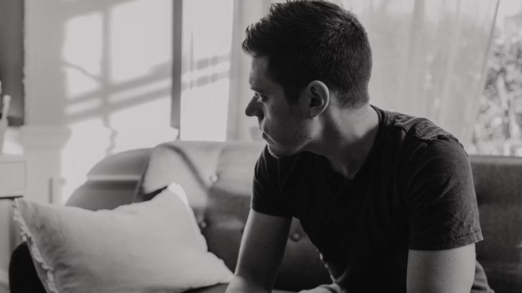 A man looking sad in the living room