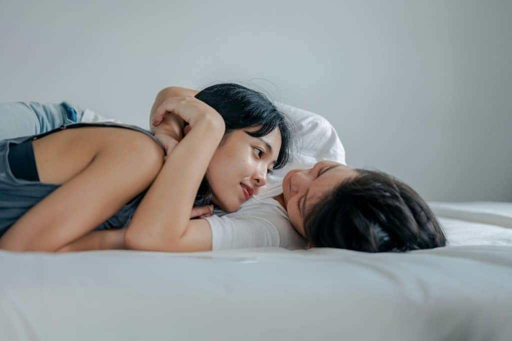 A man and woman lying at the bed