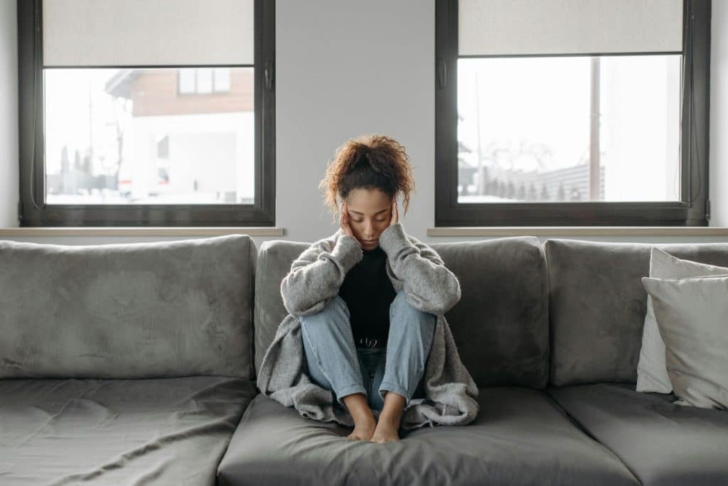A woman sitting at the couch