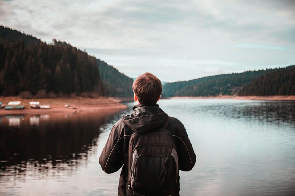 A man looking at the lake