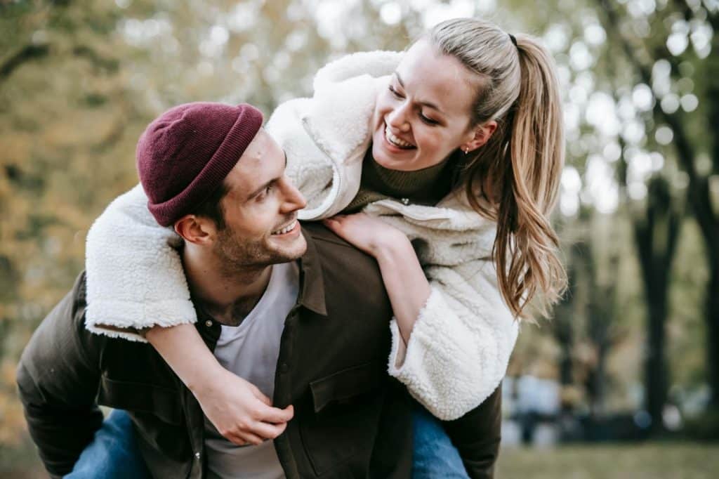 A man carrying a woman on his back