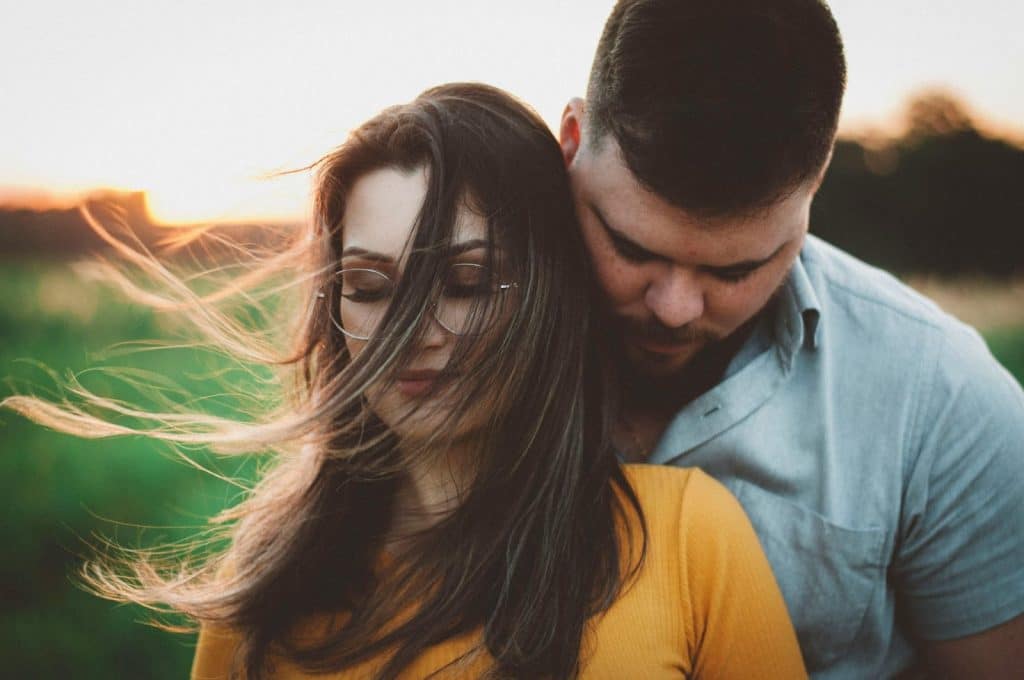 A man hugging a woman