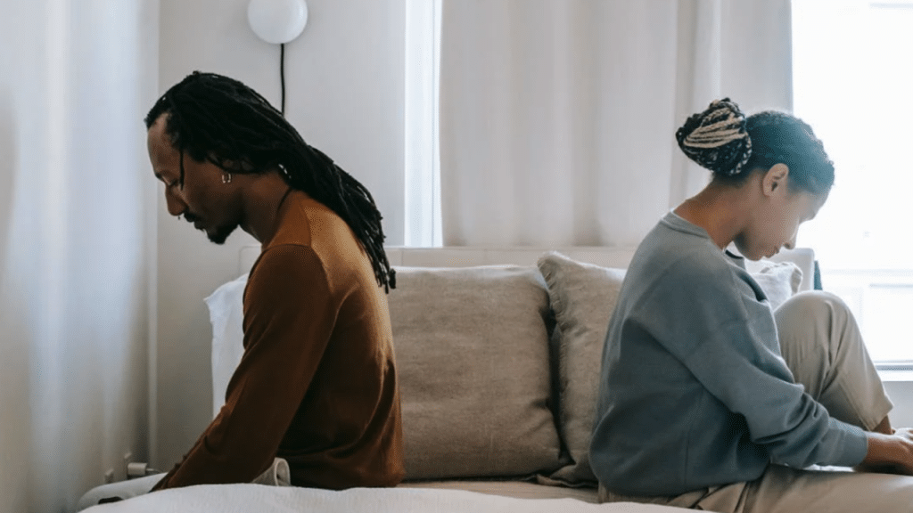 A couple looking upset in the bedroom