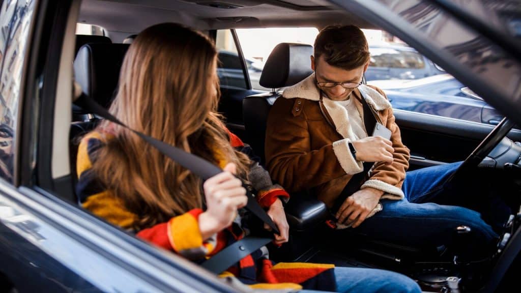 A couple fastening their seatbelts