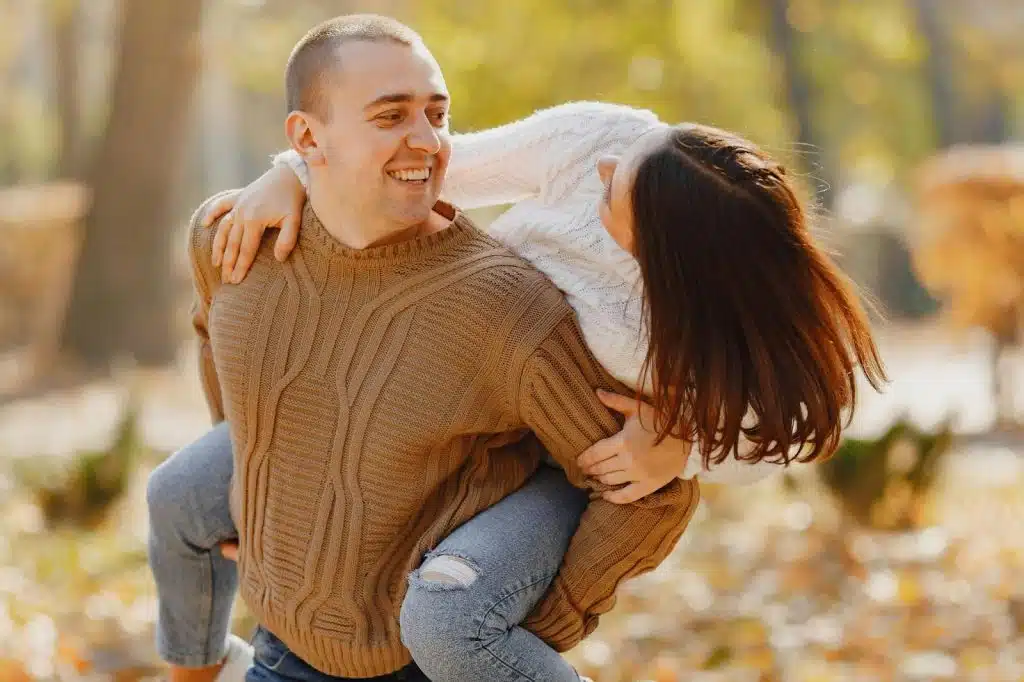 A man carrying a woman on his back