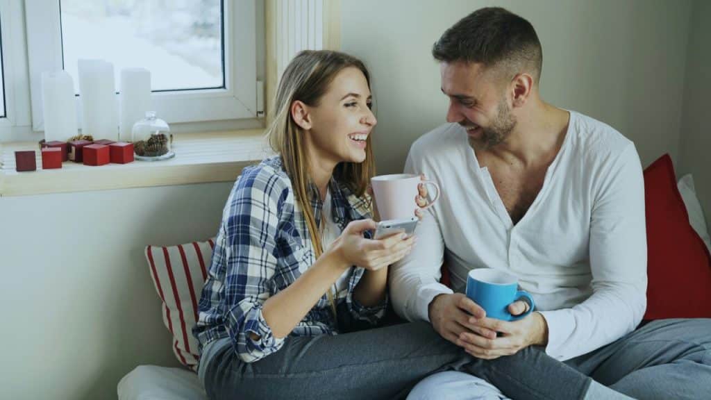 A couple laughing while having coffee
