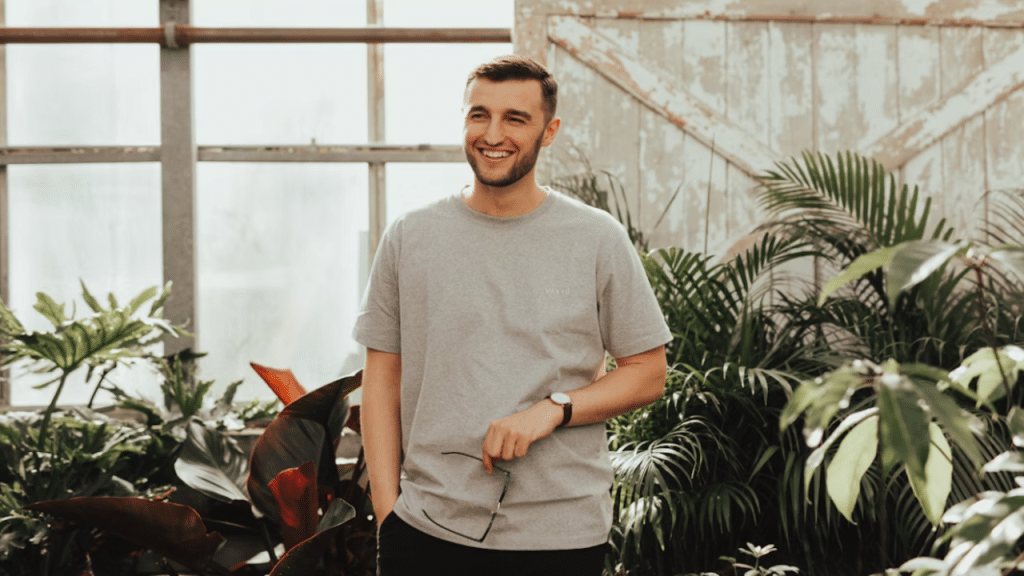 A man laughing in a green house