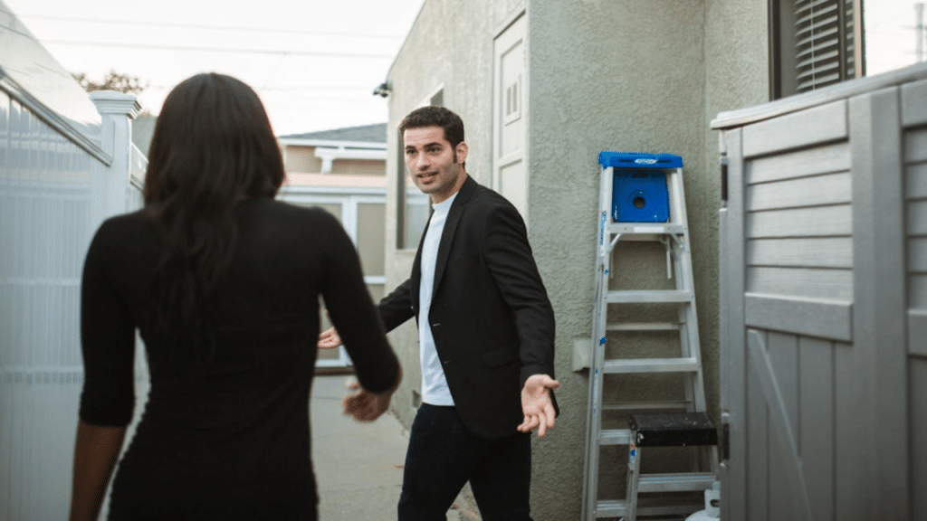 A couple fighting outside their home