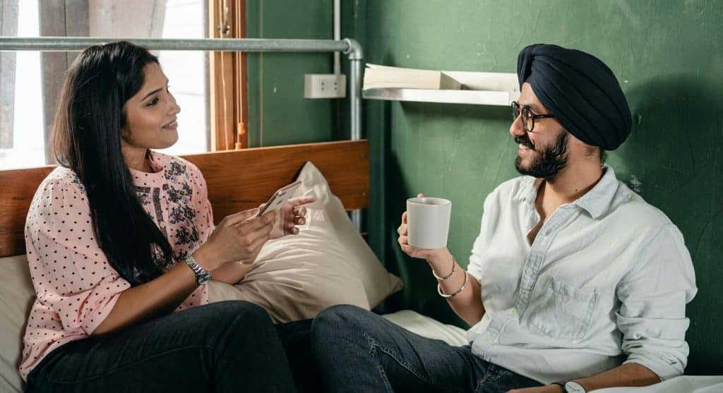 A man and woman doing their own thing