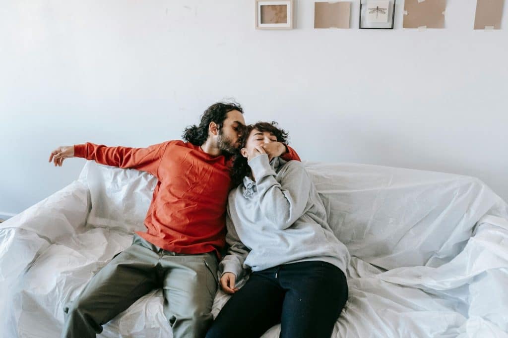 A man kissing a woman’s head