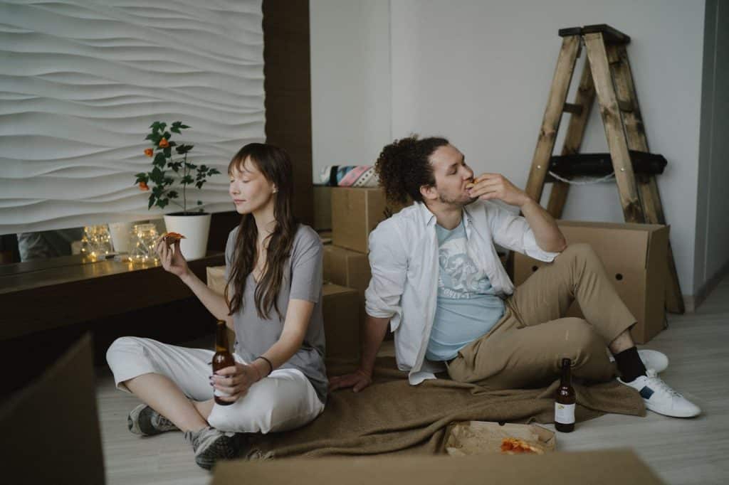 A couple sitting at the floor