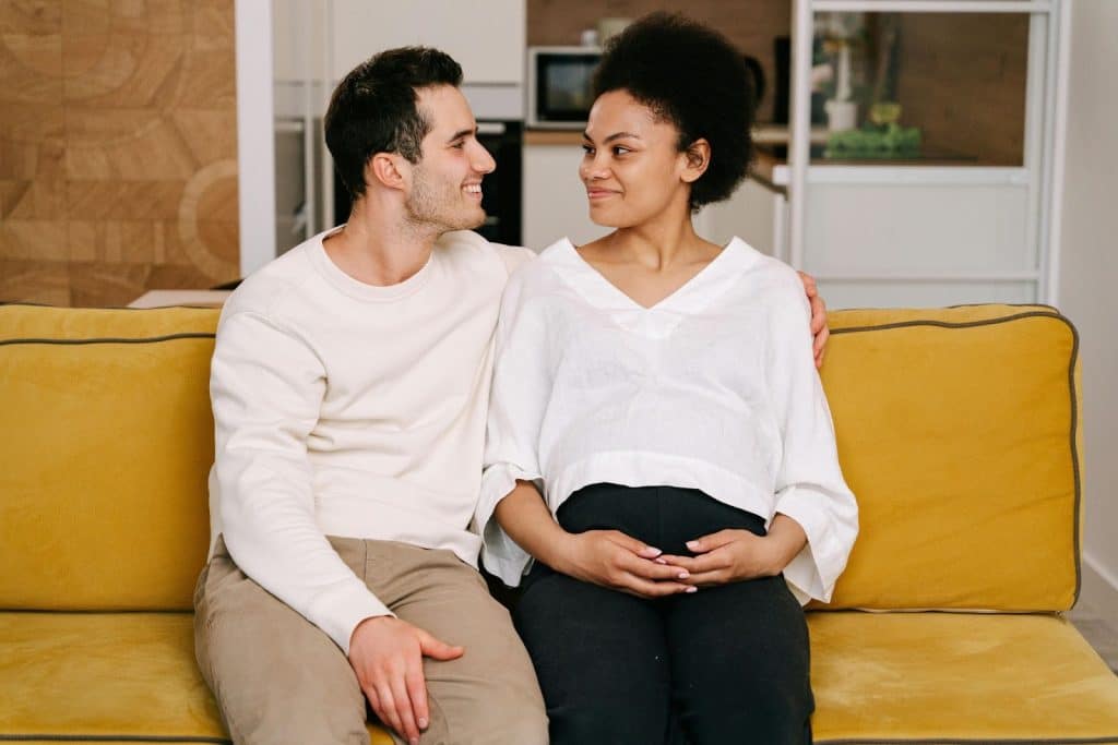 A man and woman sitting at the couch