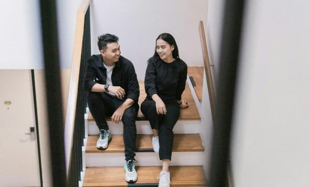 A man and woman sitting at the stairs