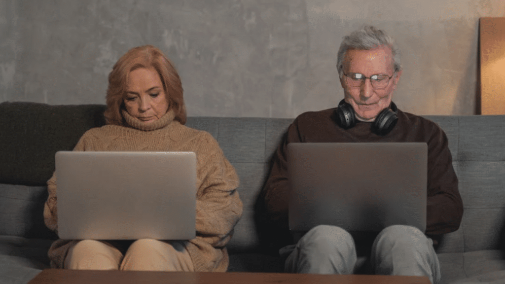 A couple using their laptops at home